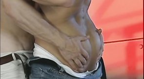 Very muscular bodybuilder is taking a huge dick in his mouth