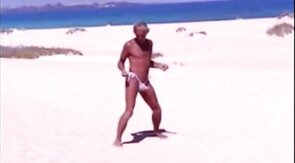 Beach Striptease: Tanned Hunk Bares All