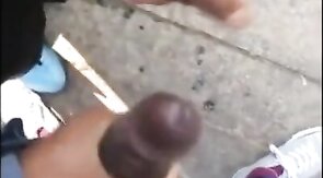 Black amateurs stroke big cocks outdoors