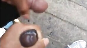 Black amateurs stroke big cocks outdoors