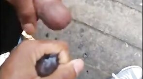 Black amateurs stroke big cocks outdoors