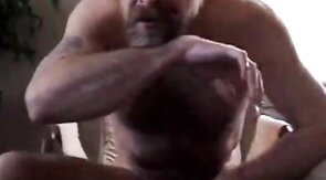 Hairy bear daddy strokes his meat