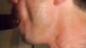 Amateur sucks big black cock at glory hole