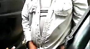 Bearded daddy strokes his cock by his truck outdoors.