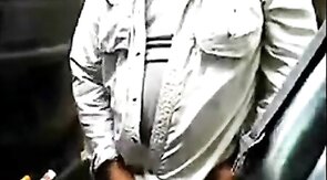 Bearded daddy strokes his cock by his truck outdoors.