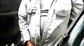 Bearded daddy strokes his cock by his truck outdoors.