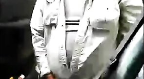 Bearded daddy strokes his cock by his truck outdoors.