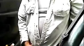 Bearded daddy strokes his cock by his truck outdoors.