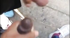 Black amateurs stroke big cocks outdoors