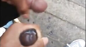 Black amateurs stroke big cocks outdoors