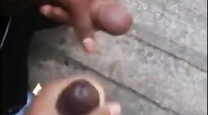 Black amateurs stroke big cocks outdoors