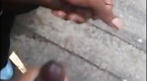 Black amateurs stroke big cocks outdoors