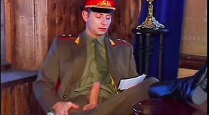 Two officers are penetrating a muscled Russian soldier