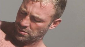 Muscled male is playing with his hard cock in the office