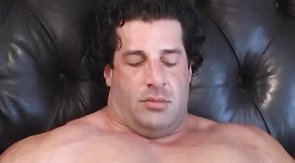 Kinky black-haired bodybuilder plays with a boner