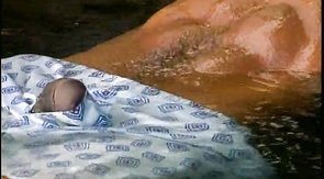 Impressive black hunk is relaxing in the pool
