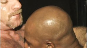 White dad is trying hard to swallow a big black rod