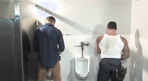 Bearded hunk gets a blowjob in a public restroom