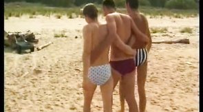 Twinks undress on the shore and jerk each other off