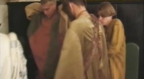 Costumed guys hanging out naked backstage