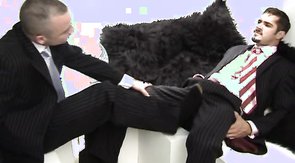 Two suit-wearing dudes seduce each other