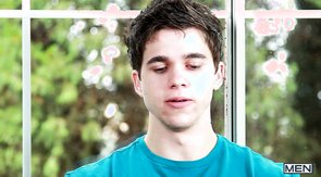 Two sexy-looking lovers are kissing in the bedroom