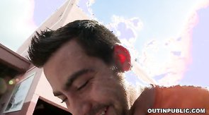 Bearded male is riding on this huge pole in public place