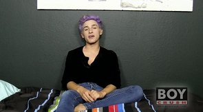 Purple hair twink stroking his meaty cock on a bed