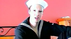 Sailor boy shows his cock and gets a nice sloppy blowjob on a bed