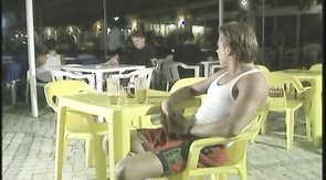 Two elegant swimmers are kissing and slowly getting naked