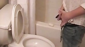 Sensual black-haired twink is undressing and wanking his dick