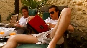 Awesome buddies are touching each other's dick on the deck chairs