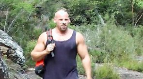 Relaxed bald bodybuilder and two mates have good outdoor action