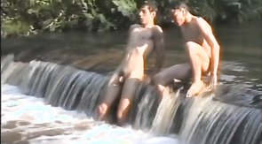 Two relaxed young men are sucking their friend's dick