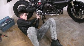 Biker is sucking a juicy loaded wiener down on the knees
