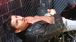 Leather-clad Latino-looking hunk jerks off in a nightclub