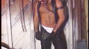 Brutal male in leather pants squeezing his hard dick