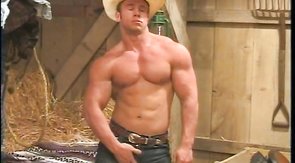 Gorgeous straight cowboy shows his muscles in the barn