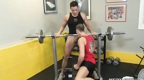 Big athlete using his barbell with his friend