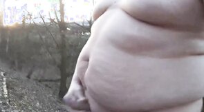 Chubby masturbates in the woods