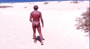 Tanned guy on beach in tiny string thong (temporarily!)