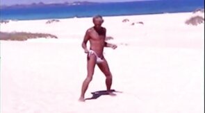 Tanned guy on beach in tiny string thong (temporarily!)