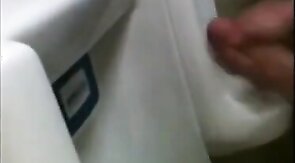 two slim dicks getting wanked at the urinals