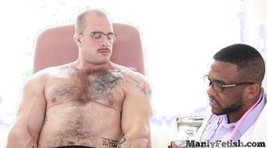 Muscled hairy hunk gets HJ by Black doctor after oil ma