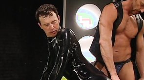 Latex guy is getting fucked by a massive black dildo
