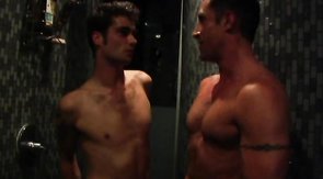 Two playful boyfriends are playing in the shower