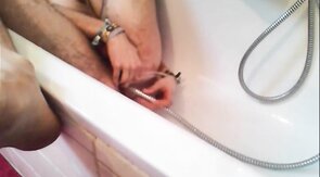 Bi-guy using shower head, squirting water, enema
