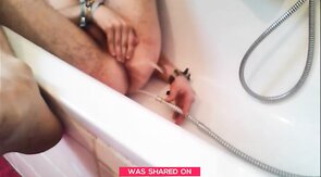 Bi-guy using shower head, squirting water, enema
